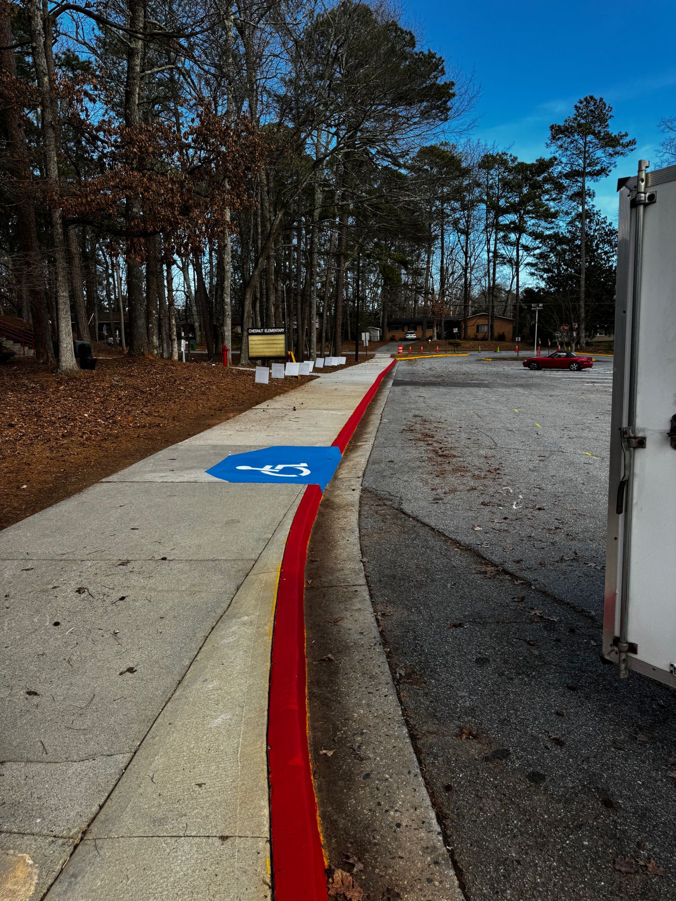 Red curb painting and ADA marking
